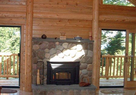 Log home bedroom with fireplace