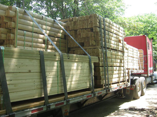 Log cabin package on truck for delivery