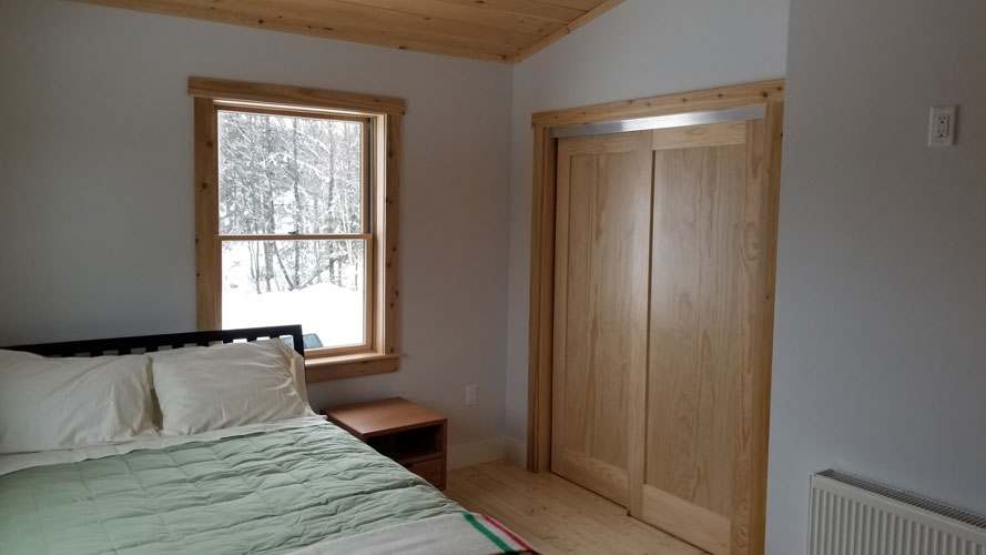 Hybrid bedroom with drywall and wood trim