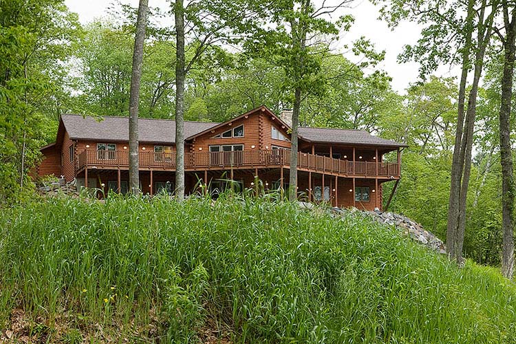 Exterior view of log home with prow front and large deck