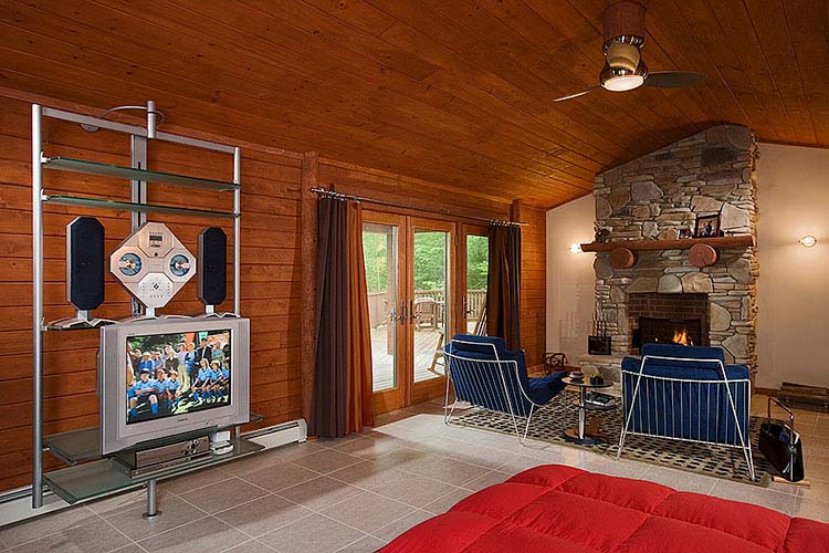 Finished basement of log home with fireplace