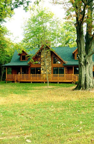 Indy log home exterior showing fireplace