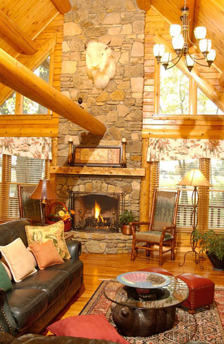 Large fireplace in log home with beams