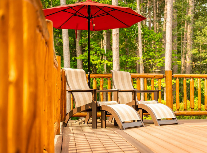 Patio chairs on the deck with an umbrella