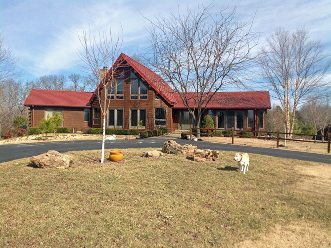 Log home with red roof