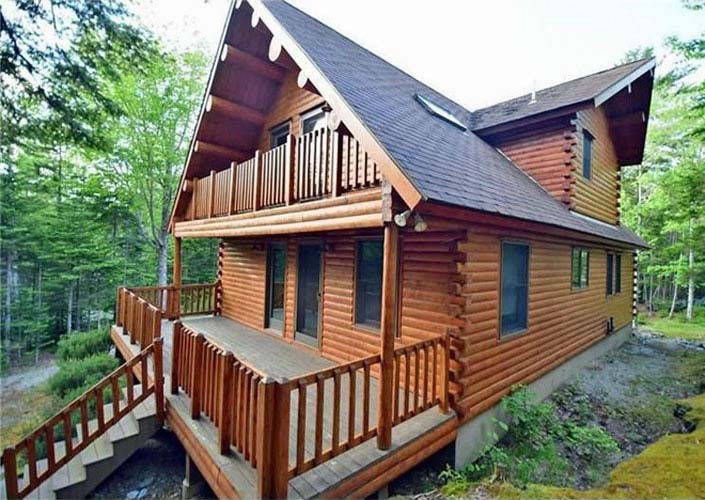 Log home exterior with deck and balcony
