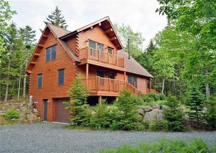 Log home exterior with garage underneath