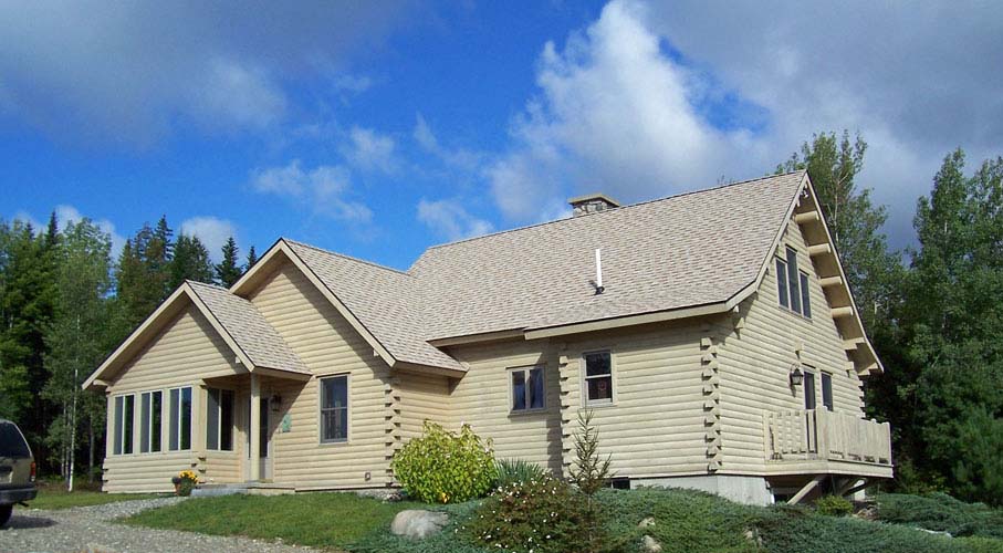 Modified log home with gray stain