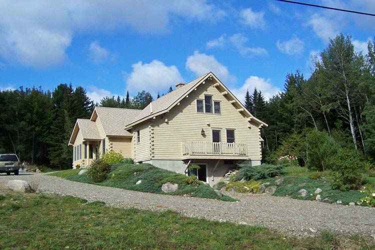 Log home view with blue sky