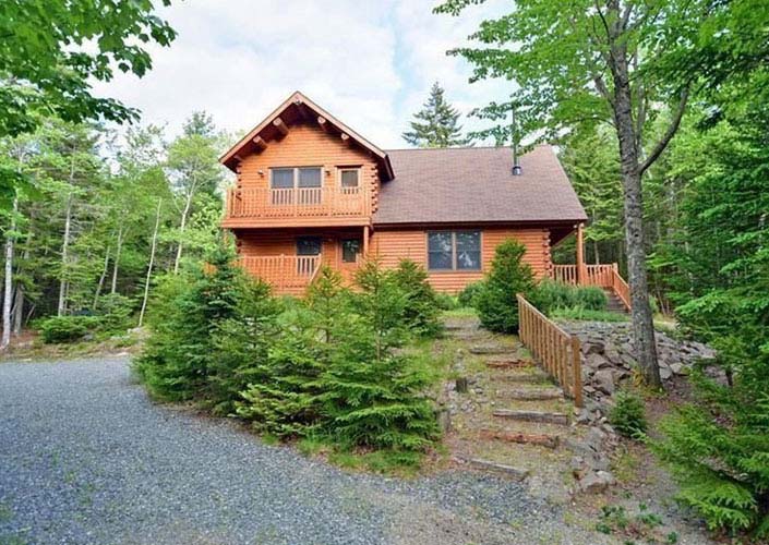 Driveway leading down to log home