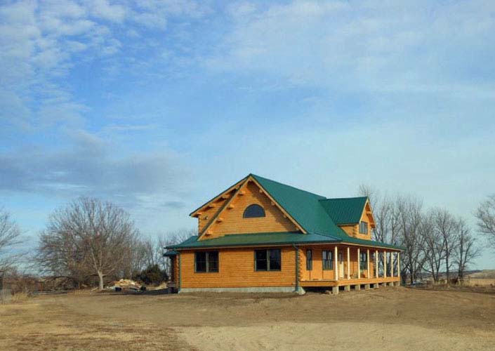 Modified Coopersburg log home in field