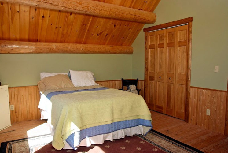 Log Home Hybrid Bedroom with beam ceiling