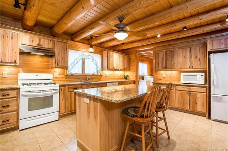 Log Home kitchen with round beams