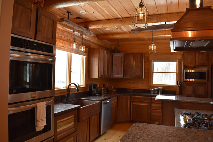 Log Home Kitchen with stainless steel appliances