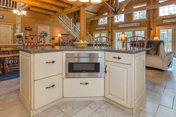 Log home kitchen white cabinets