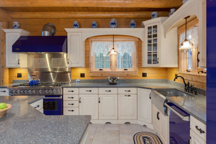 Kitchen with blue appliances and white cabinets