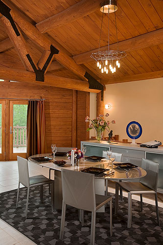 Dining room with drywall and wood beams