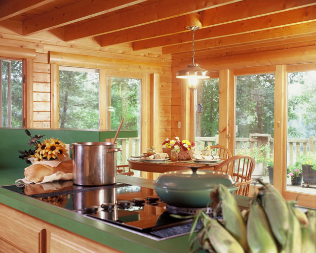 Kitchen with green counter-tops and exposed beams 