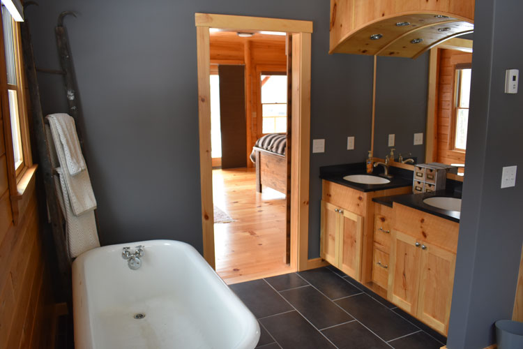 Custom Log Home Bathroom with dark blue/gray color and large soaking tub