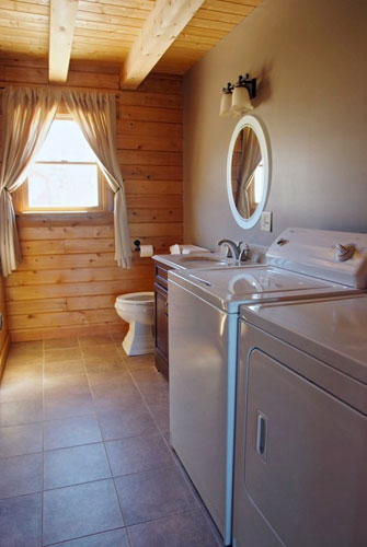 Custom Bathroom with large exposed beams and washer and dryer 