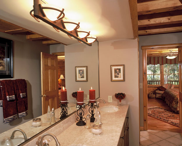 Bathroom with large counter and mirror with fancy lighting