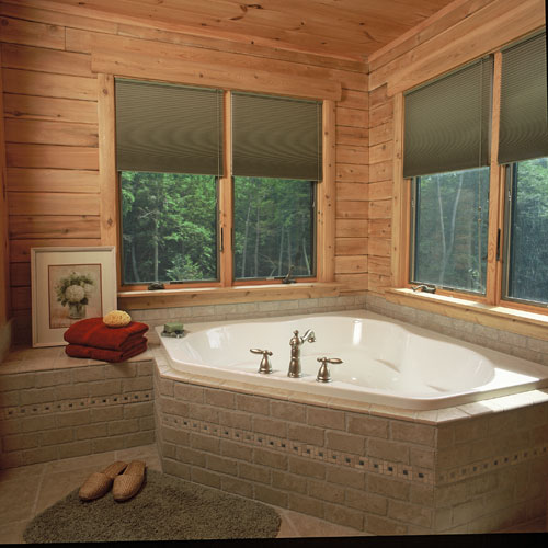 Ward's Norfolk bathroom with large corner tub with gliding windows