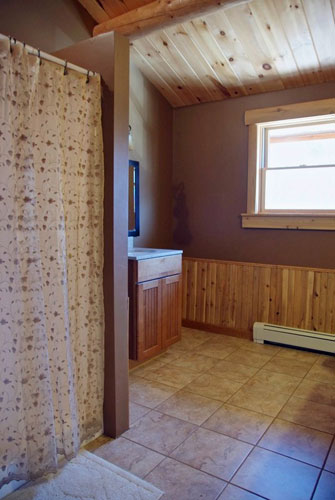 Custom log home bathroom with large walk-in shower and tile floor