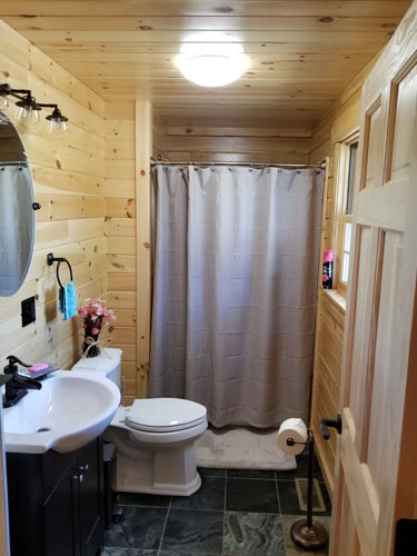Full bathroom of Musquash log cabin