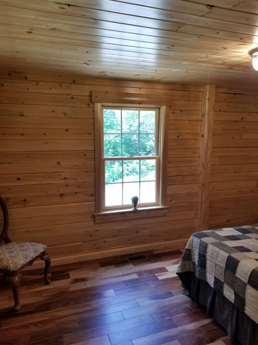 Looking at bedroom window of Musquash log cabin