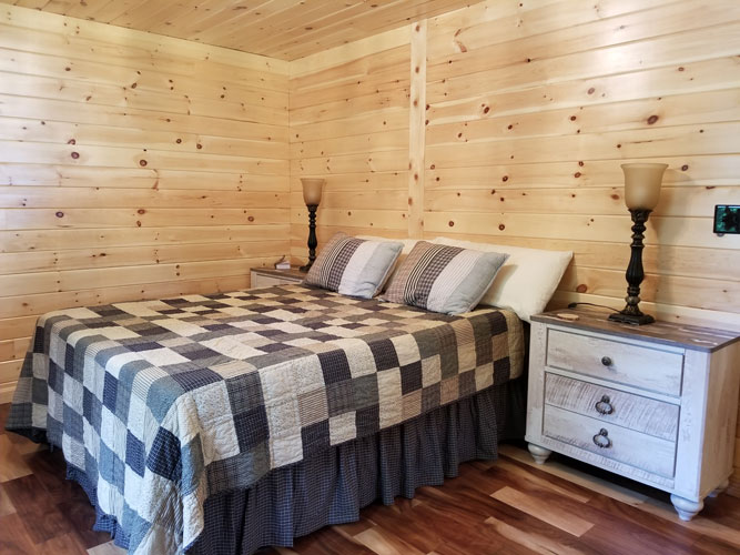 Full bedroom of Musquash log cabin