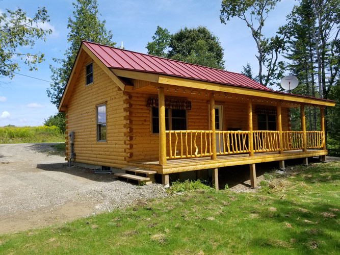 Full front view of Musquash log cabin