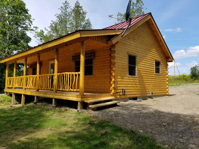 Musquash log cabin porch with custom rail