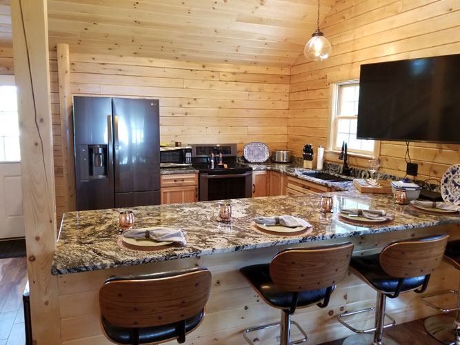 Kitchen view with granite counter tops of Ward's Musquash Log Cabin