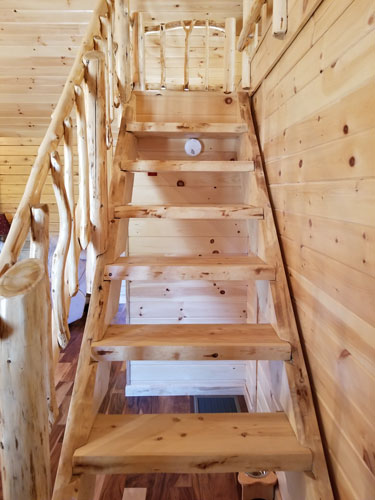 Open stairs leading to loft of Musquash log cabin