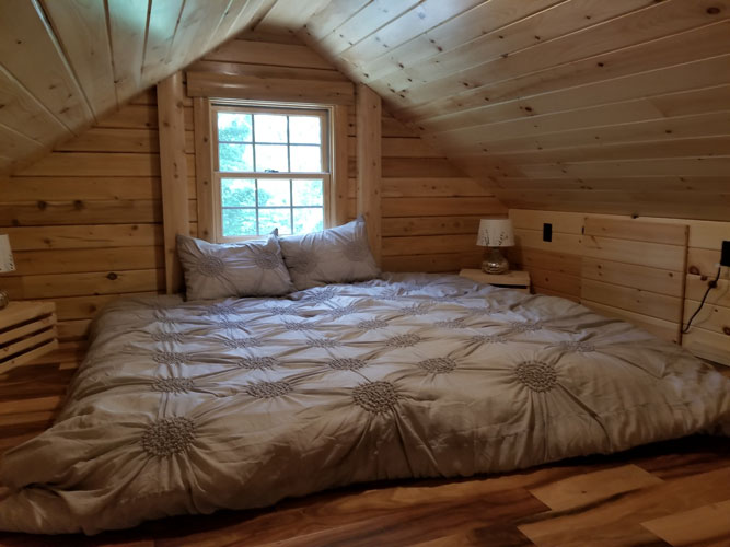 Sleeping loft area in Musquash log cabin