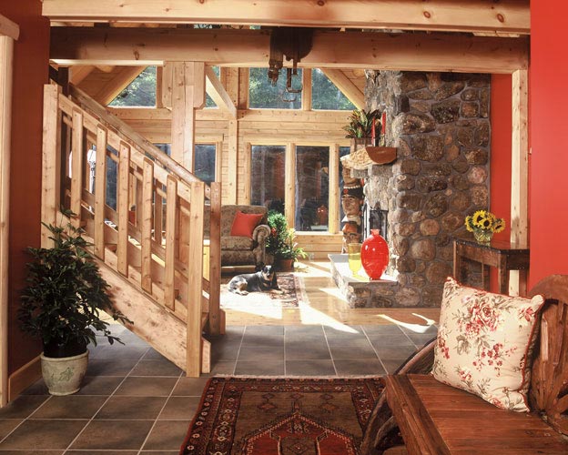Log stairs in entry way with red walls