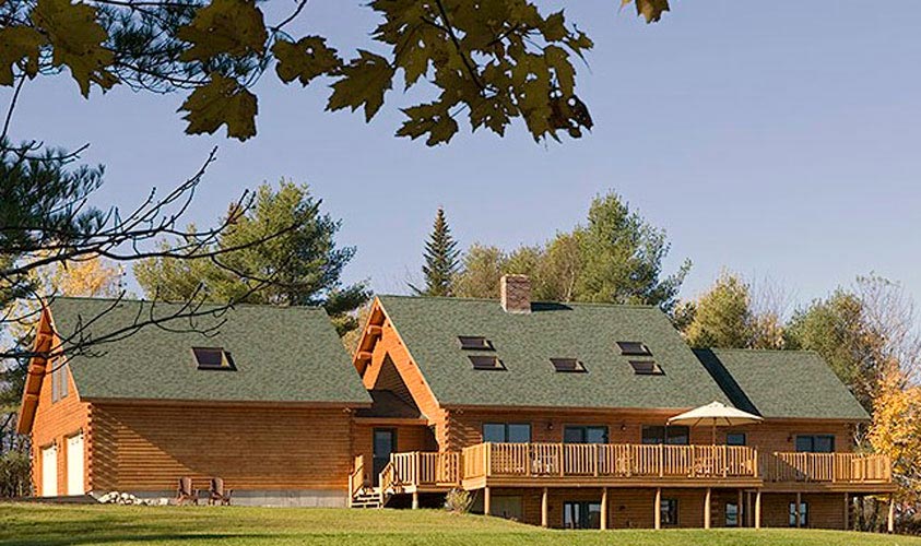 Exterior of log homes with lots of skylights