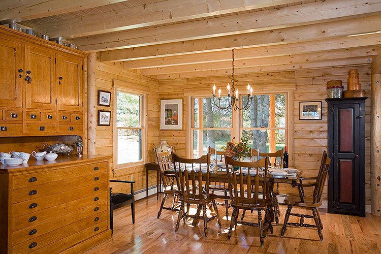 Log home dining room with exposed square ceiling joists