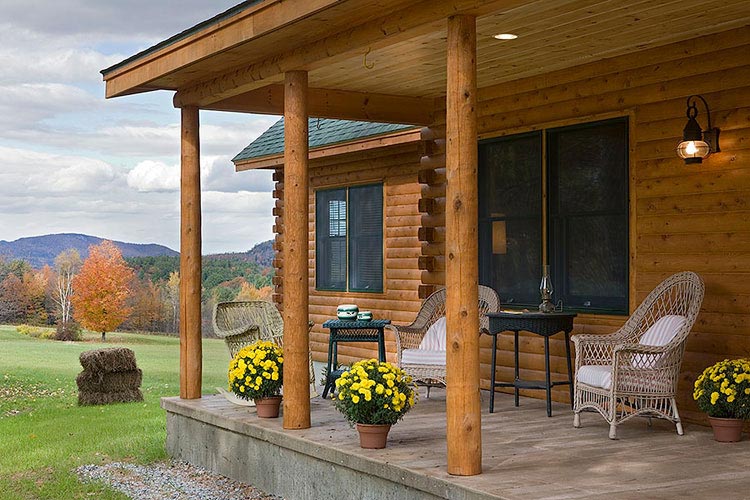 Log home porch on slab with cedar posts