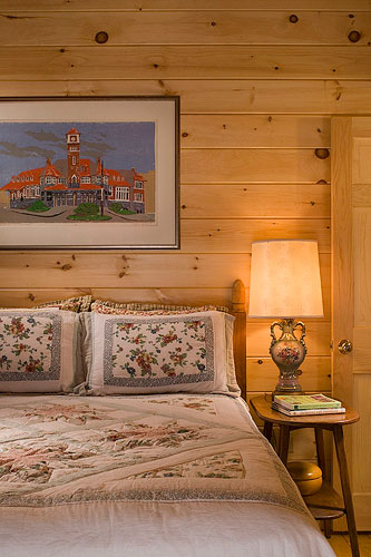 Cozy log home bedroom with nightstand