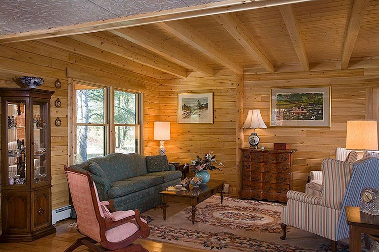 Exposed ceiling joist in log home sitting area