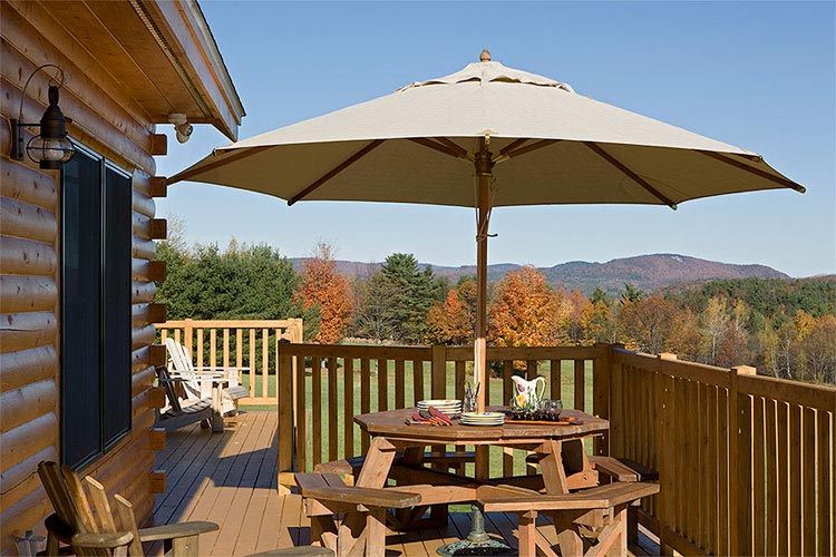 Large deck of log home looking at mountain scenery 