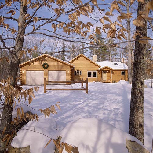 Sebago Lake Log Home Exterior with snow