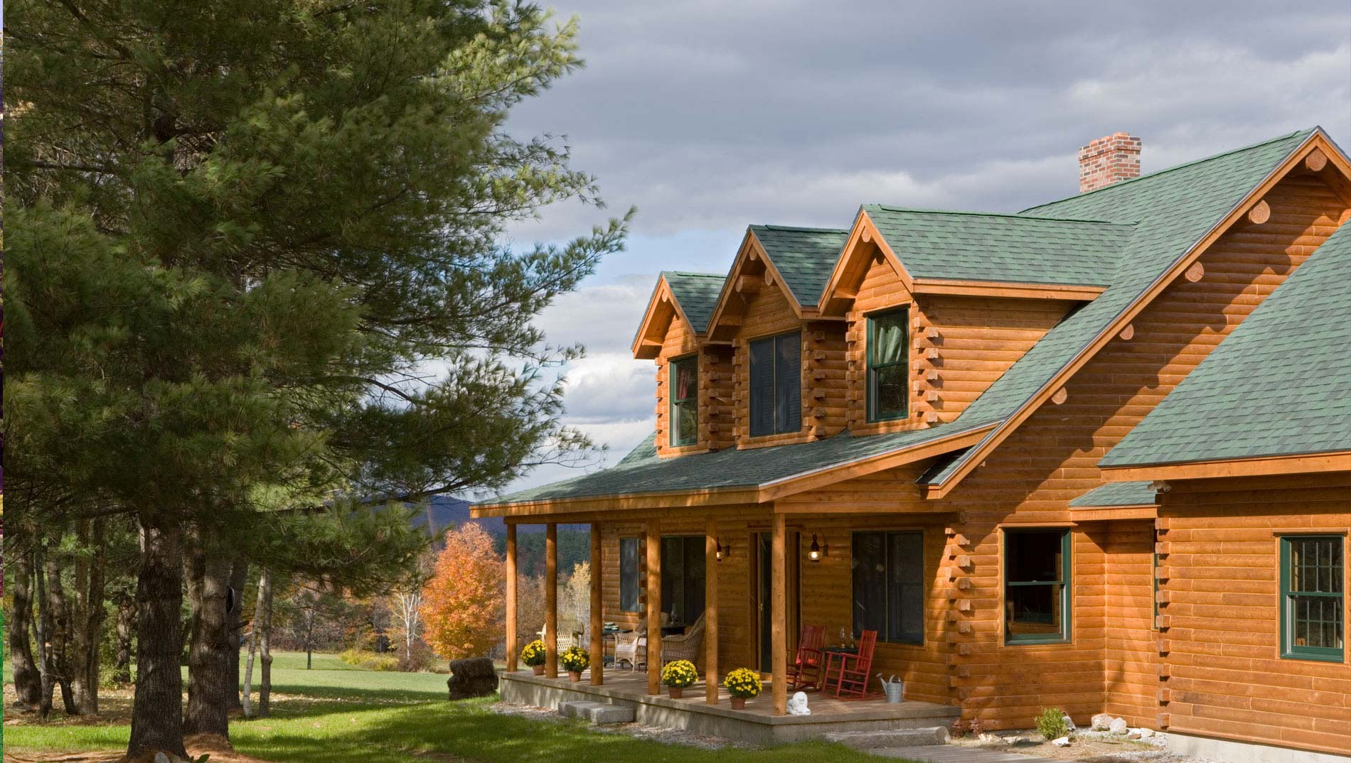 Ward Cedar Log Home Norway model with 3 gable dormers, full front porch and attached garage